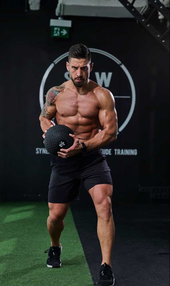 The coach is holding the kettlebell.